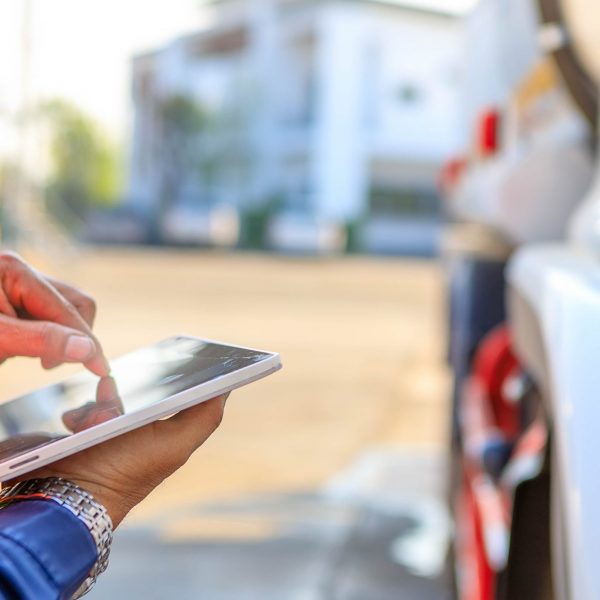 Truck drivers hand holding tablet checking the product Truck drivers hand holding tablet checking the product